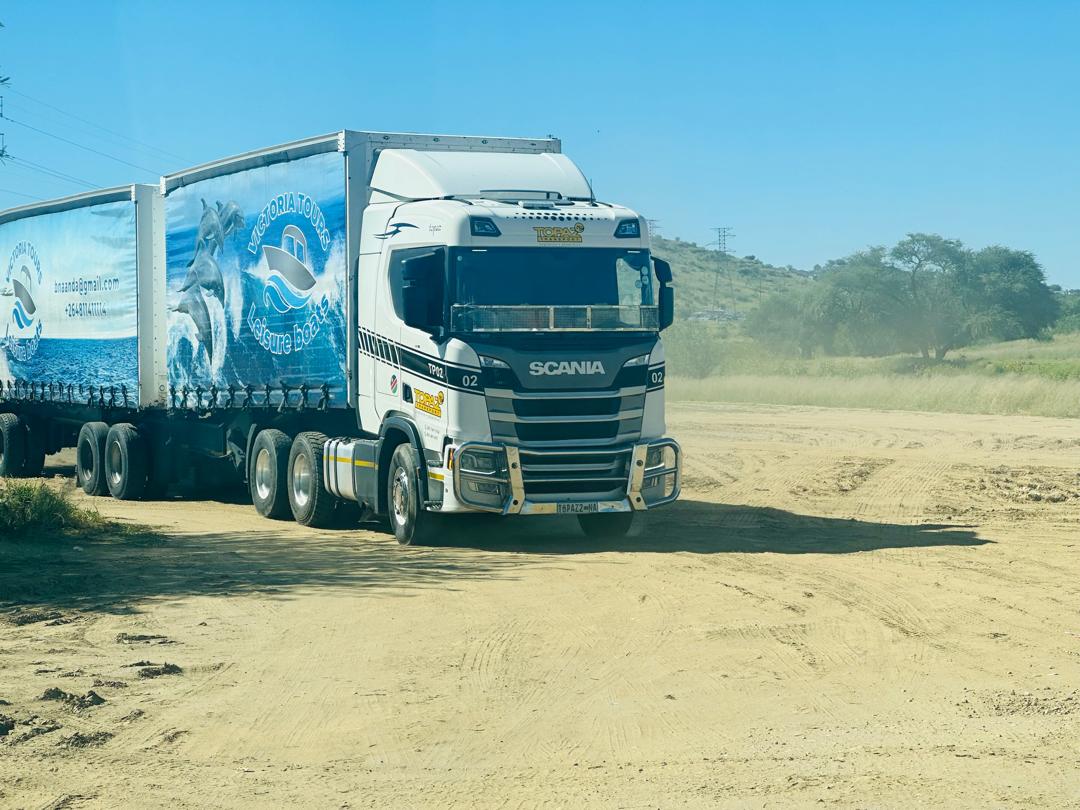 Scania TP02 with branded trailers on a gravel yard