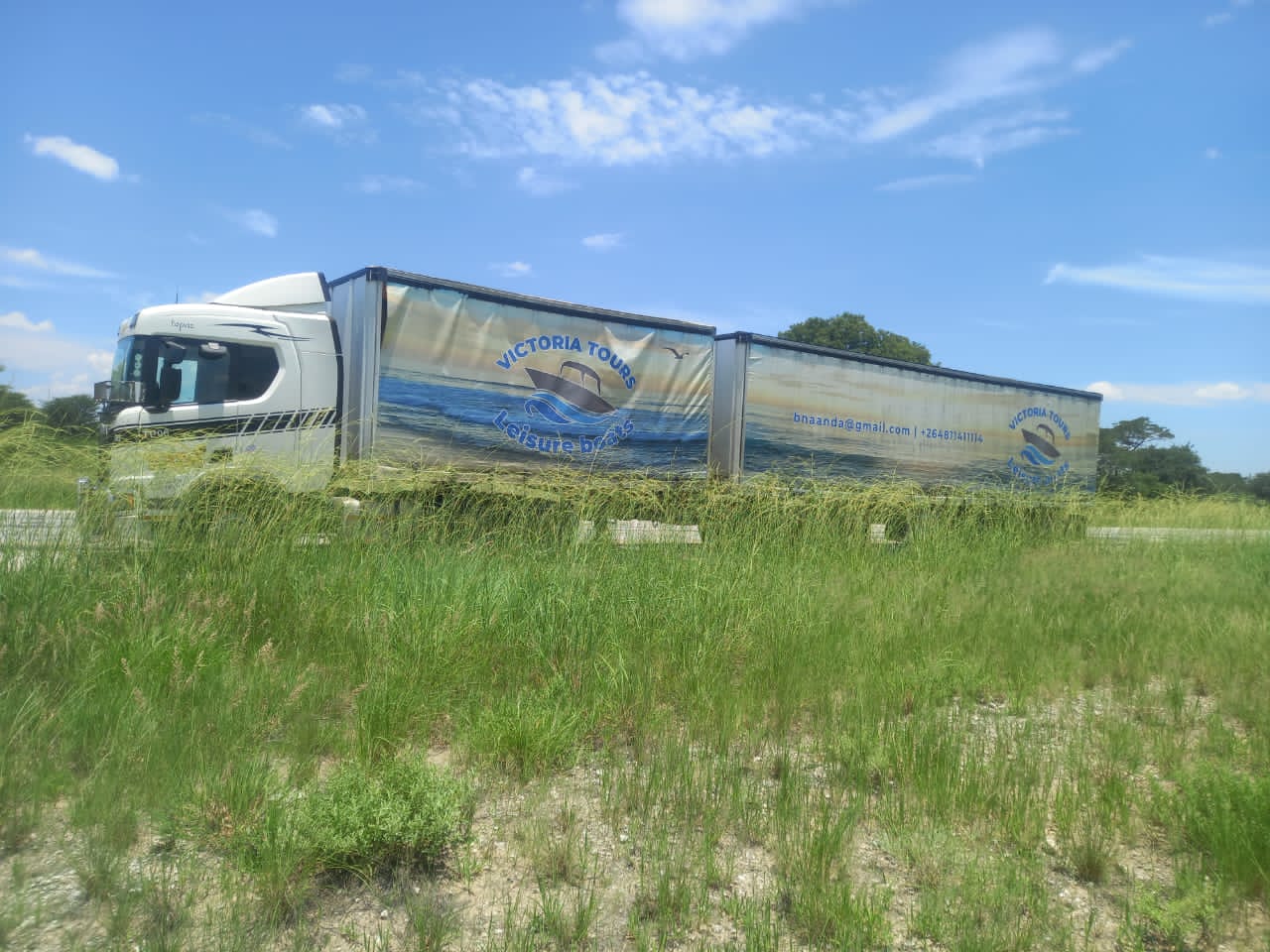 Topaz Transport Scania with two branded curtain-side trailers on a Namibian highway