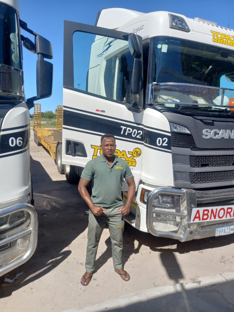 Topaz team member in branded uniform in front of the fleet